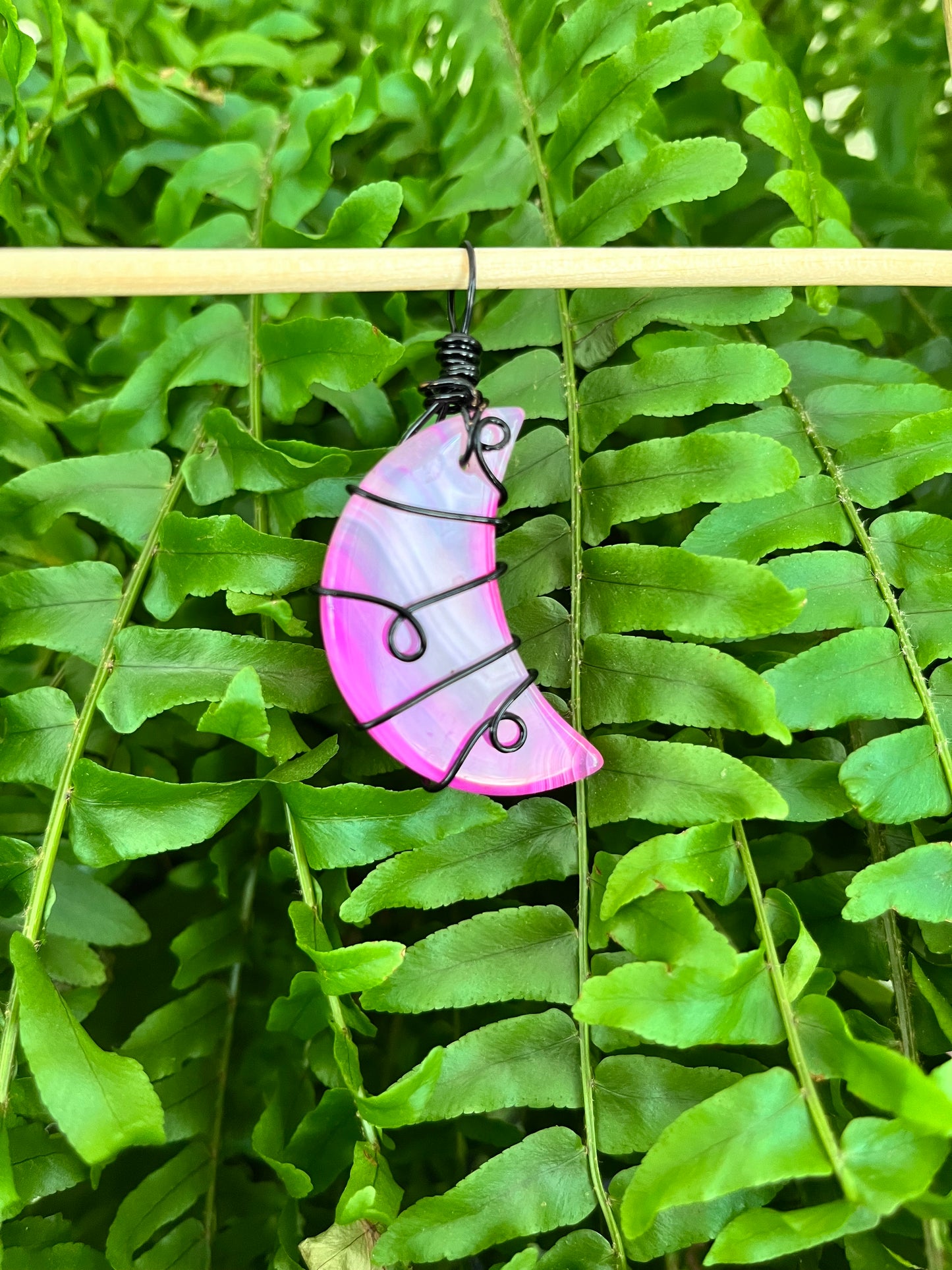 Dyed Pink Agate Crescent Moon Pendant – Black Wire Wrapped with Swirl Design